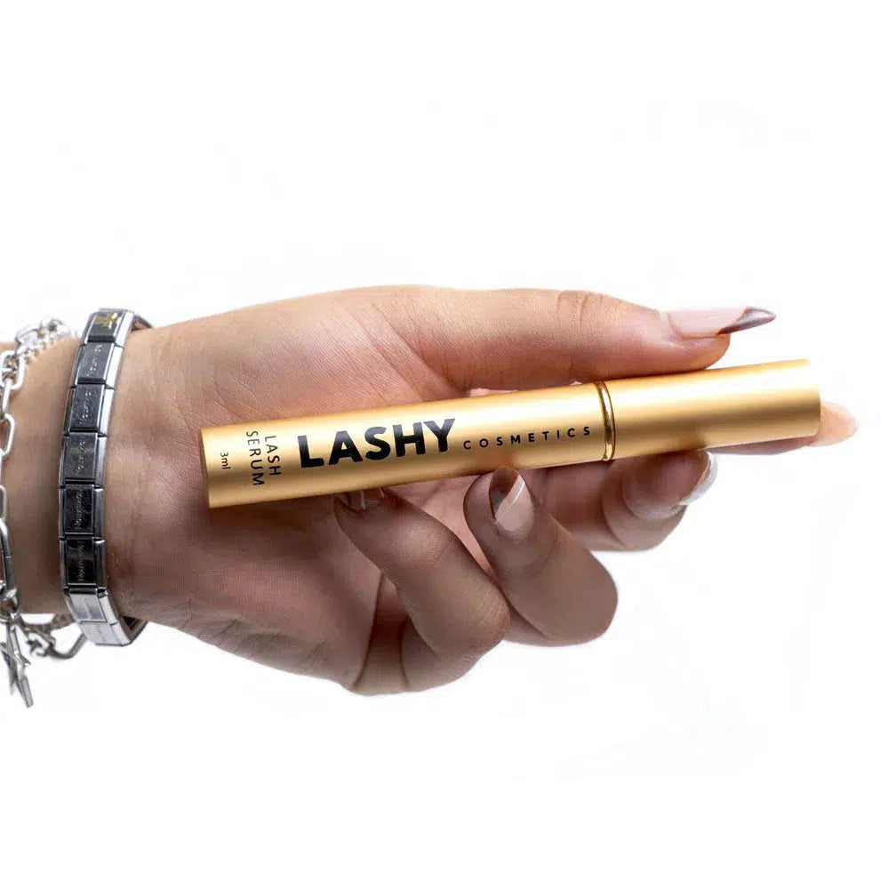 Close-up of a Lashy Cosmetics hand model with the palm facing forward, holding a Lashy Cosmetics serum bottle.